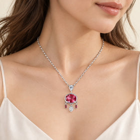 Pink topaz pendant worn over a white camisole