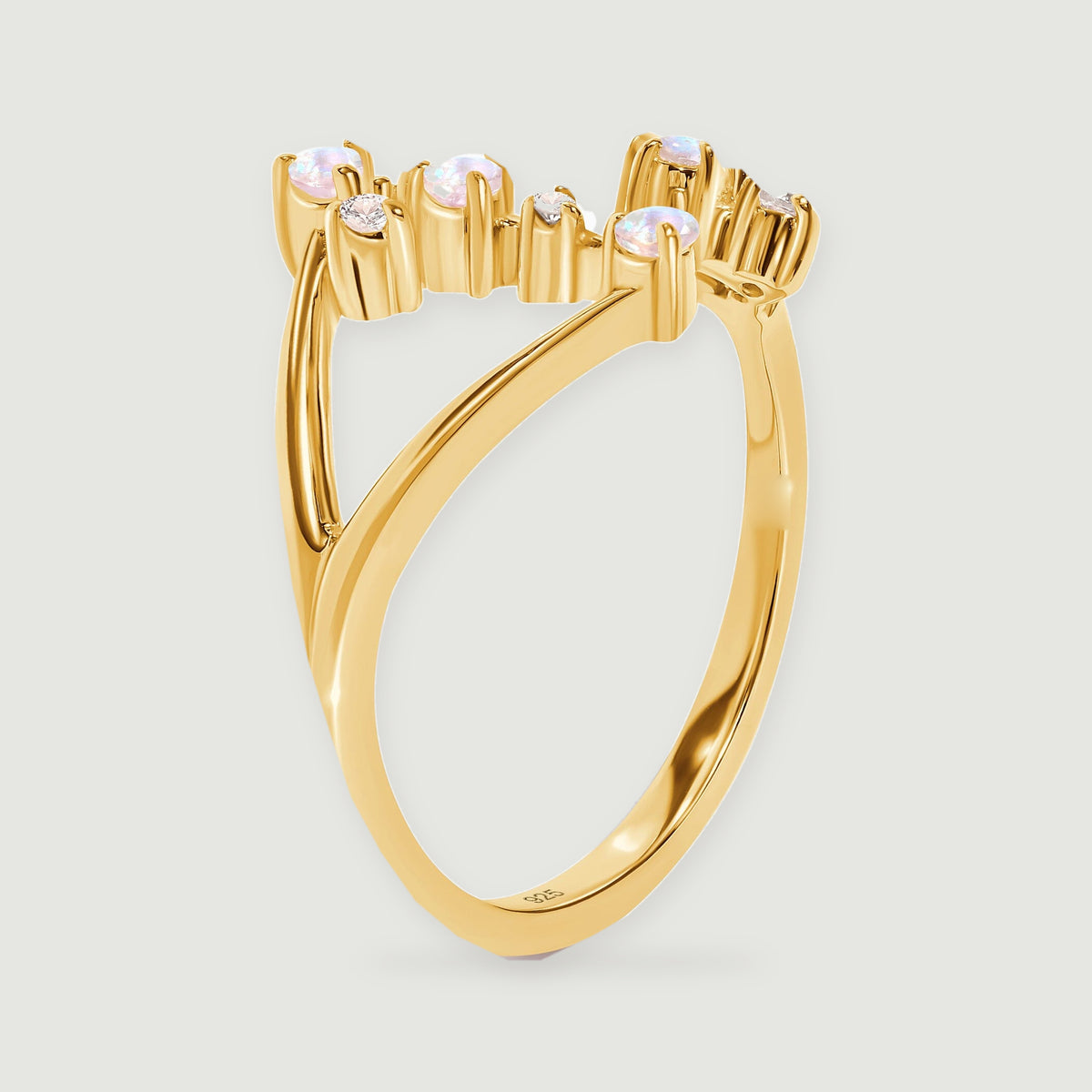 The yellow gold vermeil ring is shown from the side with raised stone settings and a curved band.