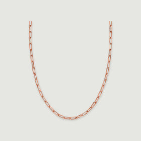 A rose gold tone chain forms a broad curve against a light grey background.