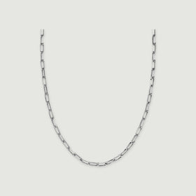 A silver tone necklace shows elongated open links on a light grey background.