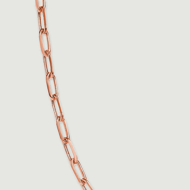 Elongated rose gold tone links connect along a close-up section of the necklace.