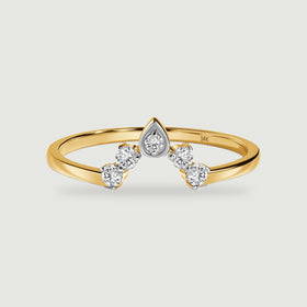 A yellow gold ring displays five round diamonds in a pointed arrangement on a light gray surface.