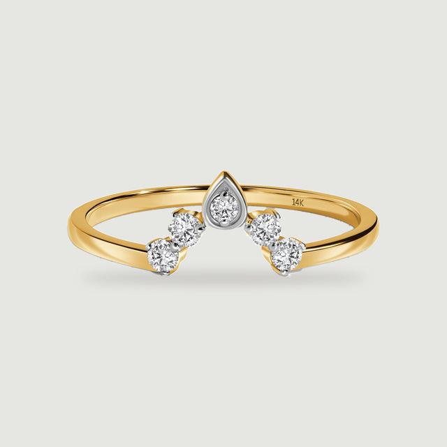A yellow gold ring displays five round diamonds in a pointed arrangement on a light gray surface.