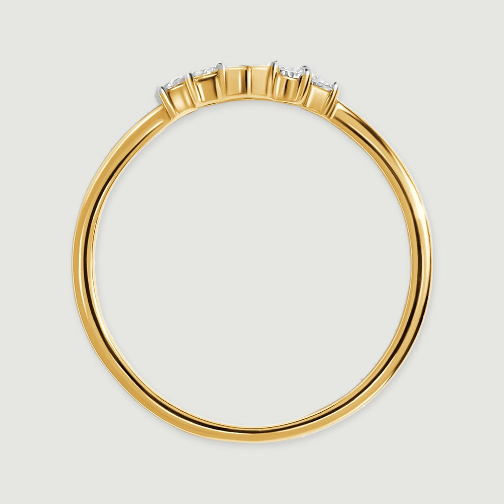 The side of a yellow gold ring reveals its circular band and the raised diamond settings.