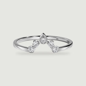 A polished white gold ring shows a pointed center setting and two round diamonds on each side.