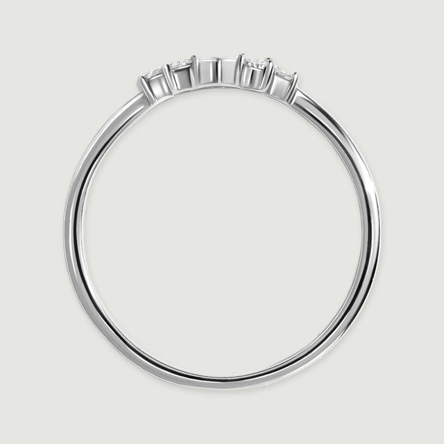 The white gold ring is viewed from the side, showing slender prongs above its polished band.