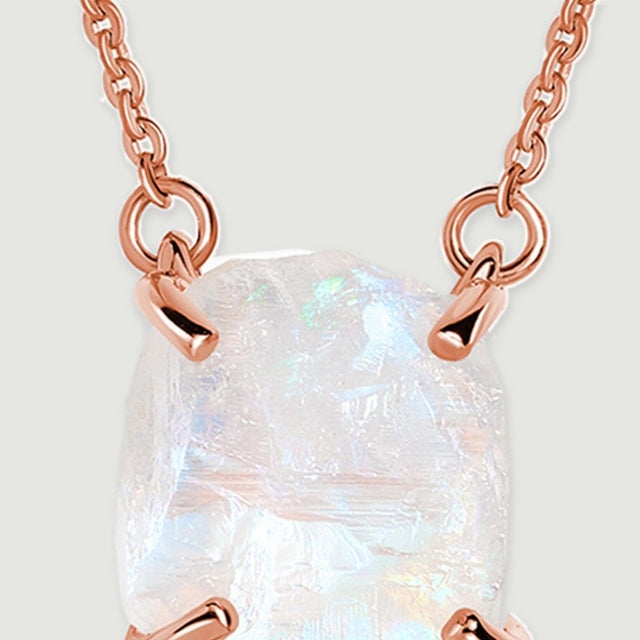 Two rose gold attachment loops connect the fine chain to the upper corners of the raw moonstone pendant.