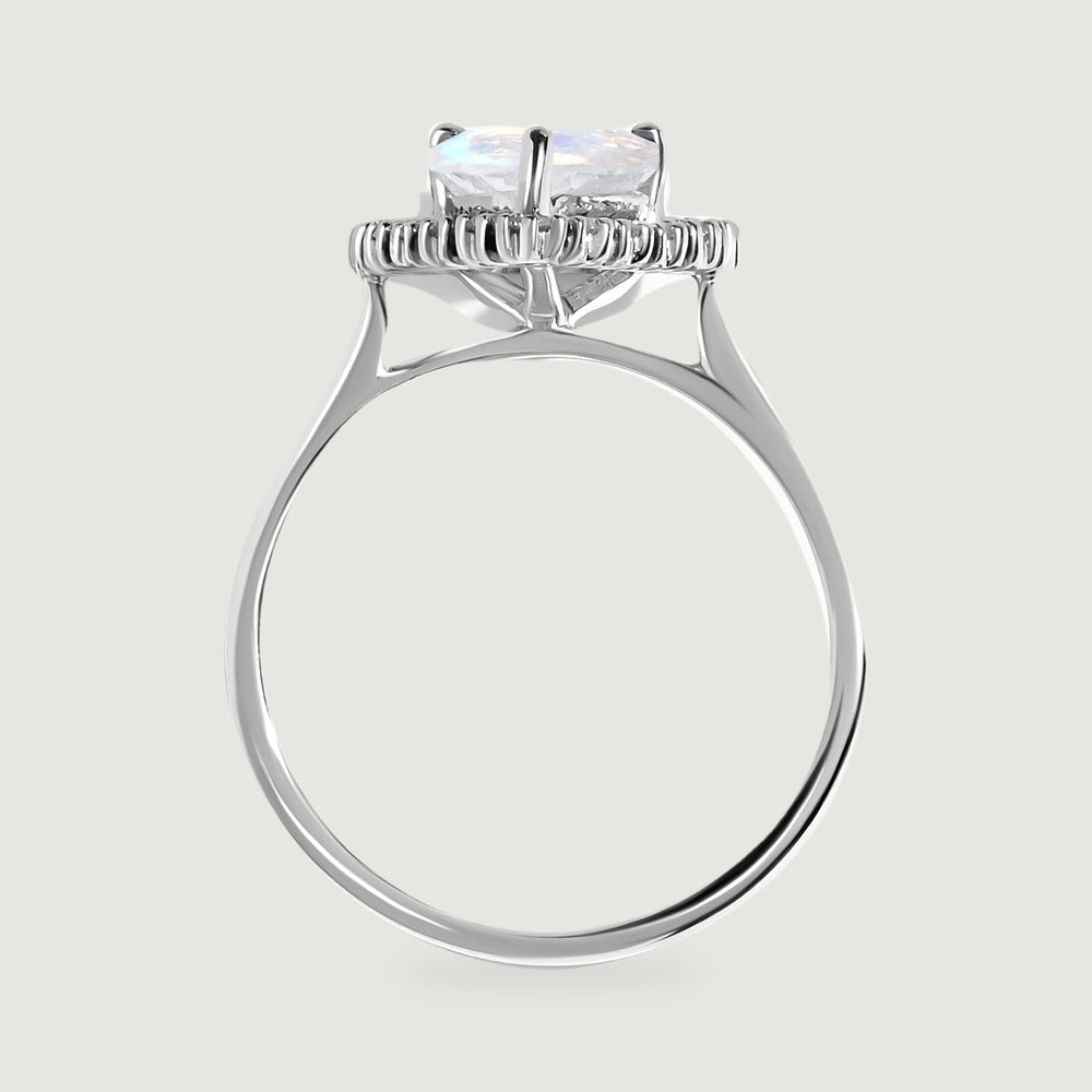 The side view shows the raised moonstone setting, diamond halo, open gallery, and polished white gold band.