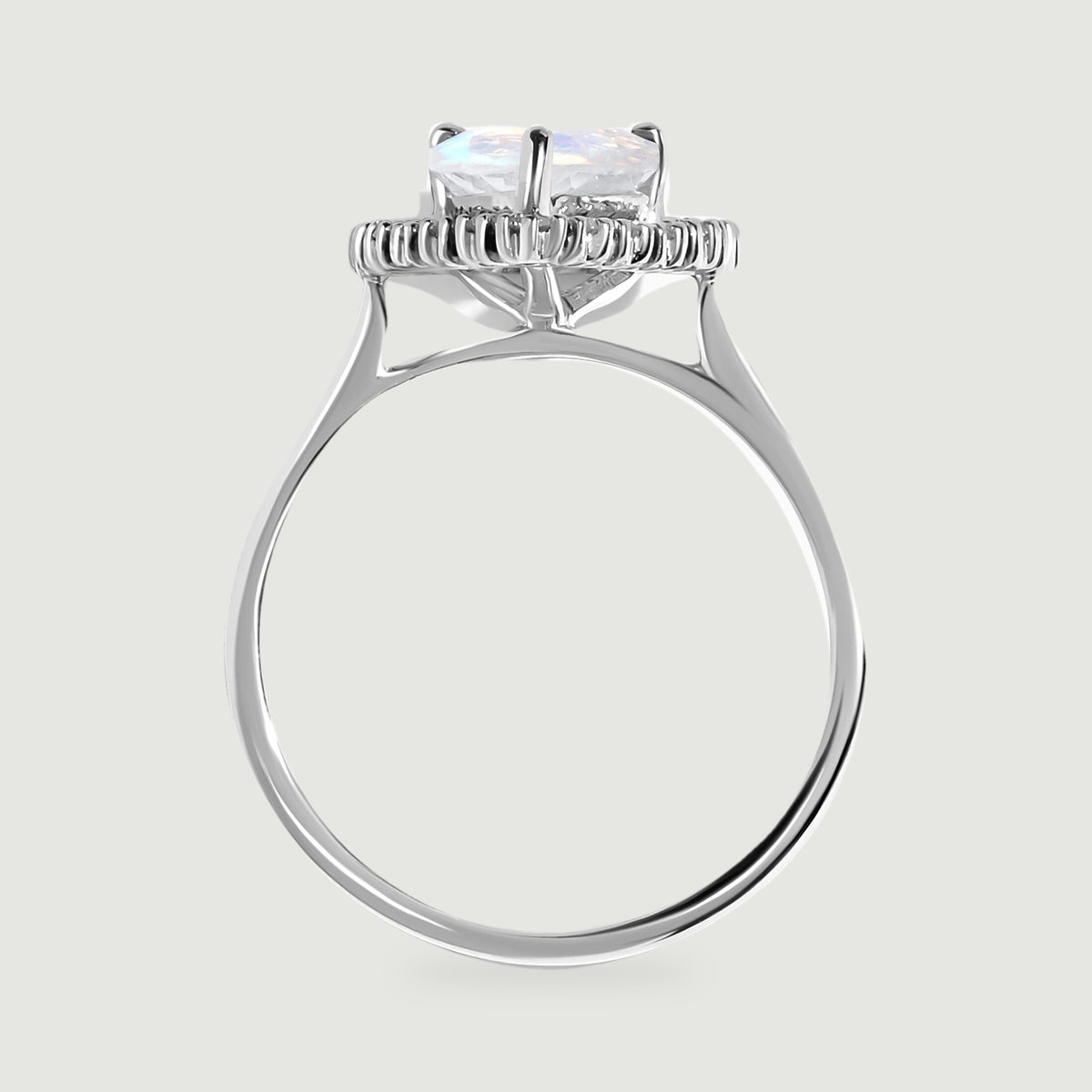 The side view shows the raised moonstone setting, diamond halo, open gallery, and polished white gold band.