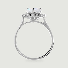 The side view shows the raised moonstone setting, diamond halo, open gallery, and polished white gold band.