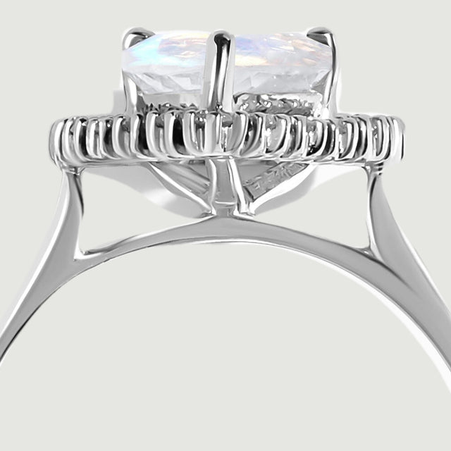 A close-up shows the moonstone above the halo and the open white gold support beneath the setting.