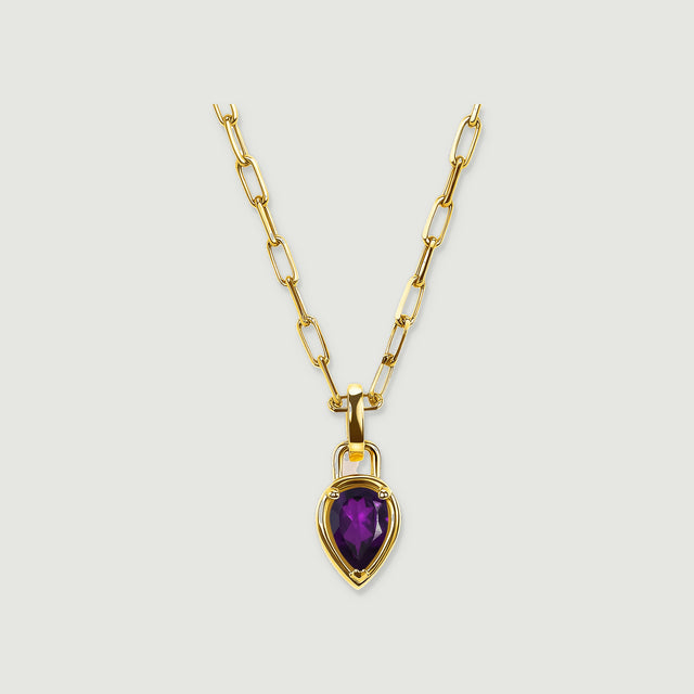 A yellow gold plated link necklace with a purple pear-shaped pendant is centered on a pale gray background.