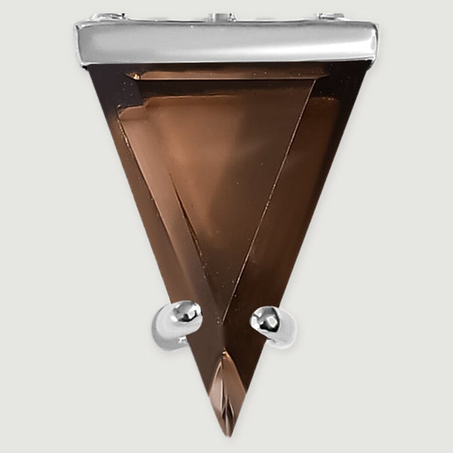The brown step-cut smoky quartz shows angular facets and two silver prongs near its pointed tip on a light gray background.