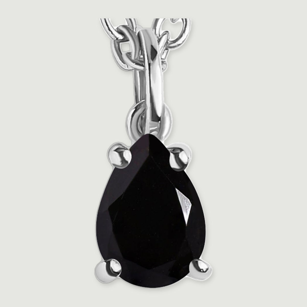 The silver-colored pendant loop and four-prong setting frame a reflective pear-shaped black stone.