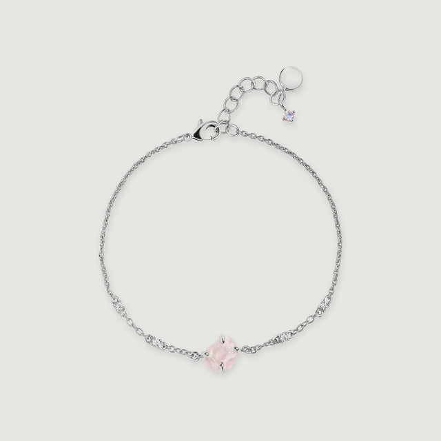 A silver tone chain curves around a raw pink quartz centerpiece with four clear accent stones and an adjustable clasp.