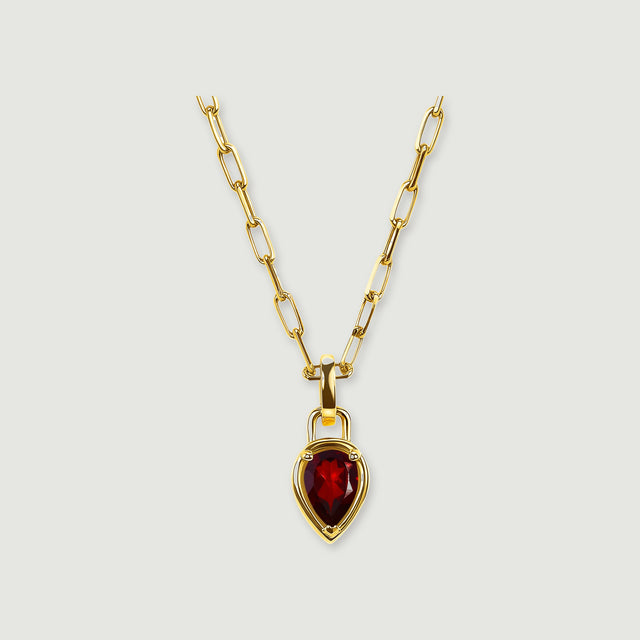 A pear-shaped red garnet pendant hangs from a yellow gold-tone rectangular-link chain on a light gray background.