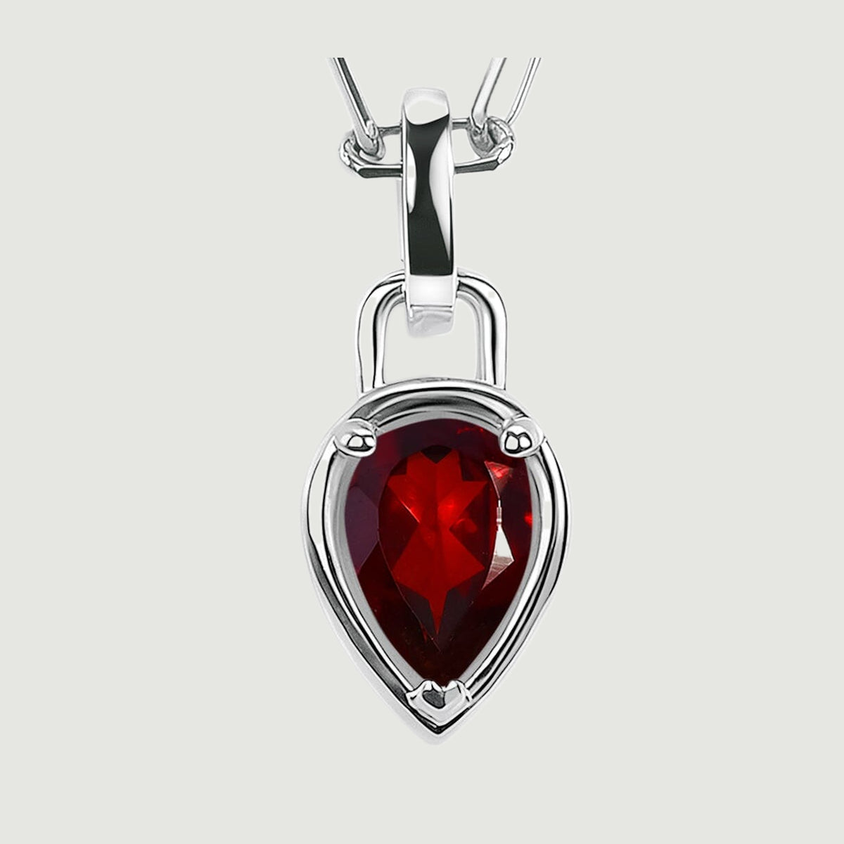 Three rounded prongs secure a dark red faceted garnet beneath a broad polished silver-tone bail.