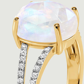 The elevated oval stone and diamond-lined split shoulder are visible from the side.