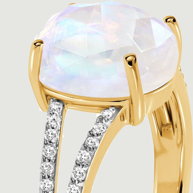The elevated oval stone and diamond-lined split shoulder are visible from the side.