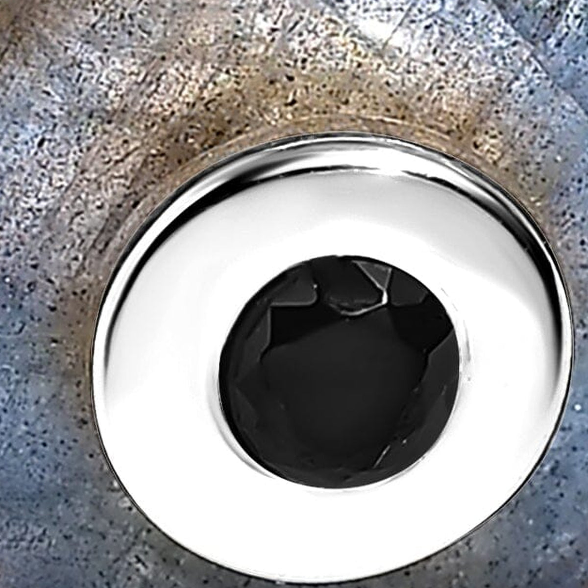 The polished sterling silver centre bezel and black faceted stone appear in close detail against blue-grey labradorite.