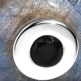 The polished sterling silver centre bezel and black faceted stone appear in close detail against blue-grey labradorite.