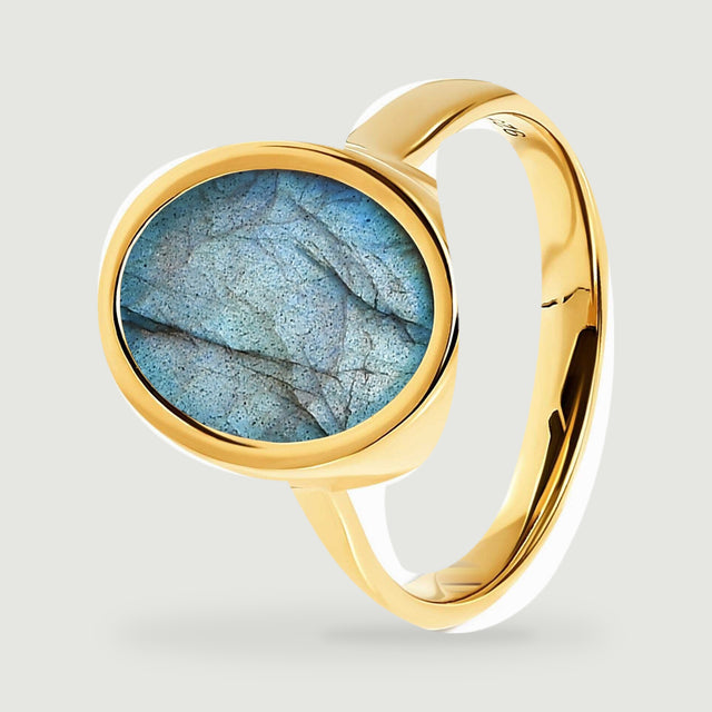 A tilted yellow gold vermeil ring reveals the oval stone setting and rounded band.