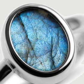 A close view shows blue mineral veining within the oval labradorite and its silver bezel.