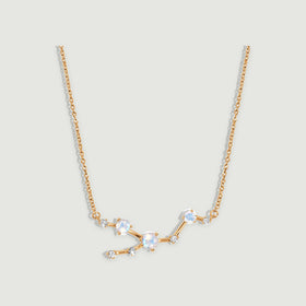A yellow gold necklace displays three round moonstones and five small clear stones along an angular linked centerpiece.