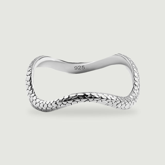A complete polished silver ring has a curved band and raised oval texture on a light gray background.