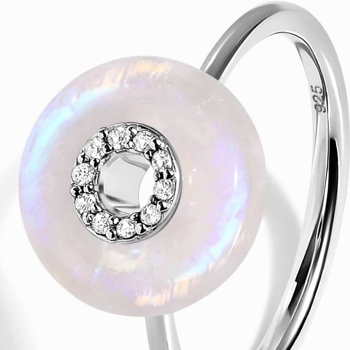 A close-up of the pale moonstone face, individual clear stones and the slender silver band.