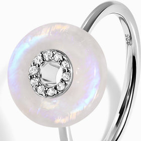 A close-up of the pale moonstone face, individual clear stones and the slender silver band.