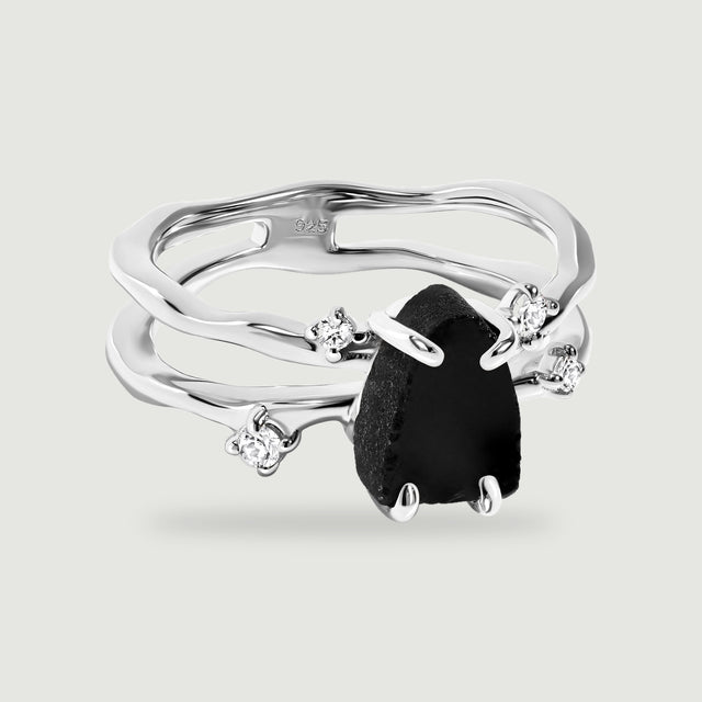 A sterling silver split band ring holds a black obsidian stone between four bright round accents.