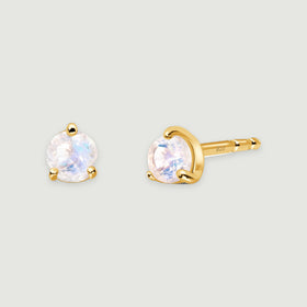 A pair of yellow gold vermeil moonstone studs shows a front view and an angled view on a light gray surface.