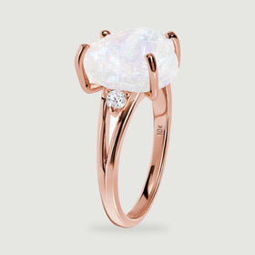 The side of the rose gold ring shows the raised rough moonstone setting and the open split band.