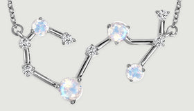 Silver bars connect four round iridescent stones and smaller clear stones across the open constellation pendant.