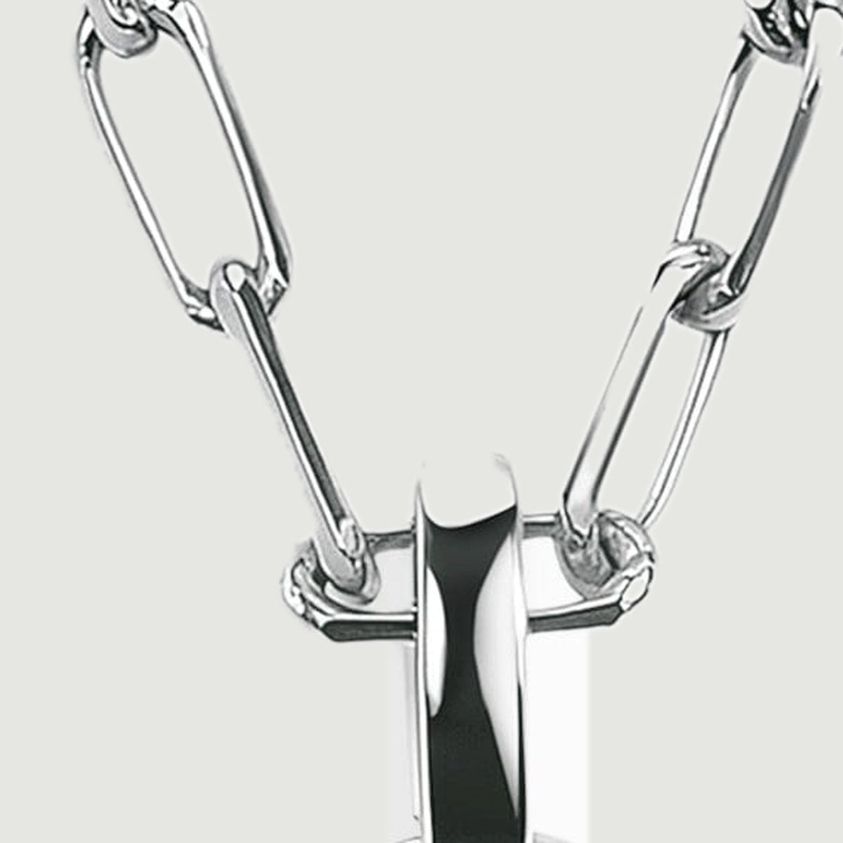 Interlocking silver-colored elongated links meet a broad polished bail against a light gray background.