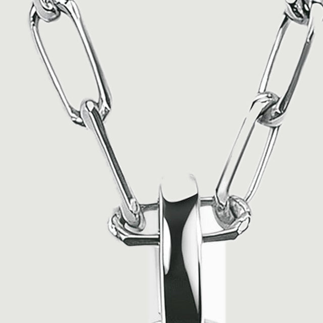 Interlocking silver-colored elongated links meet a broad polished bail against a light gray background.