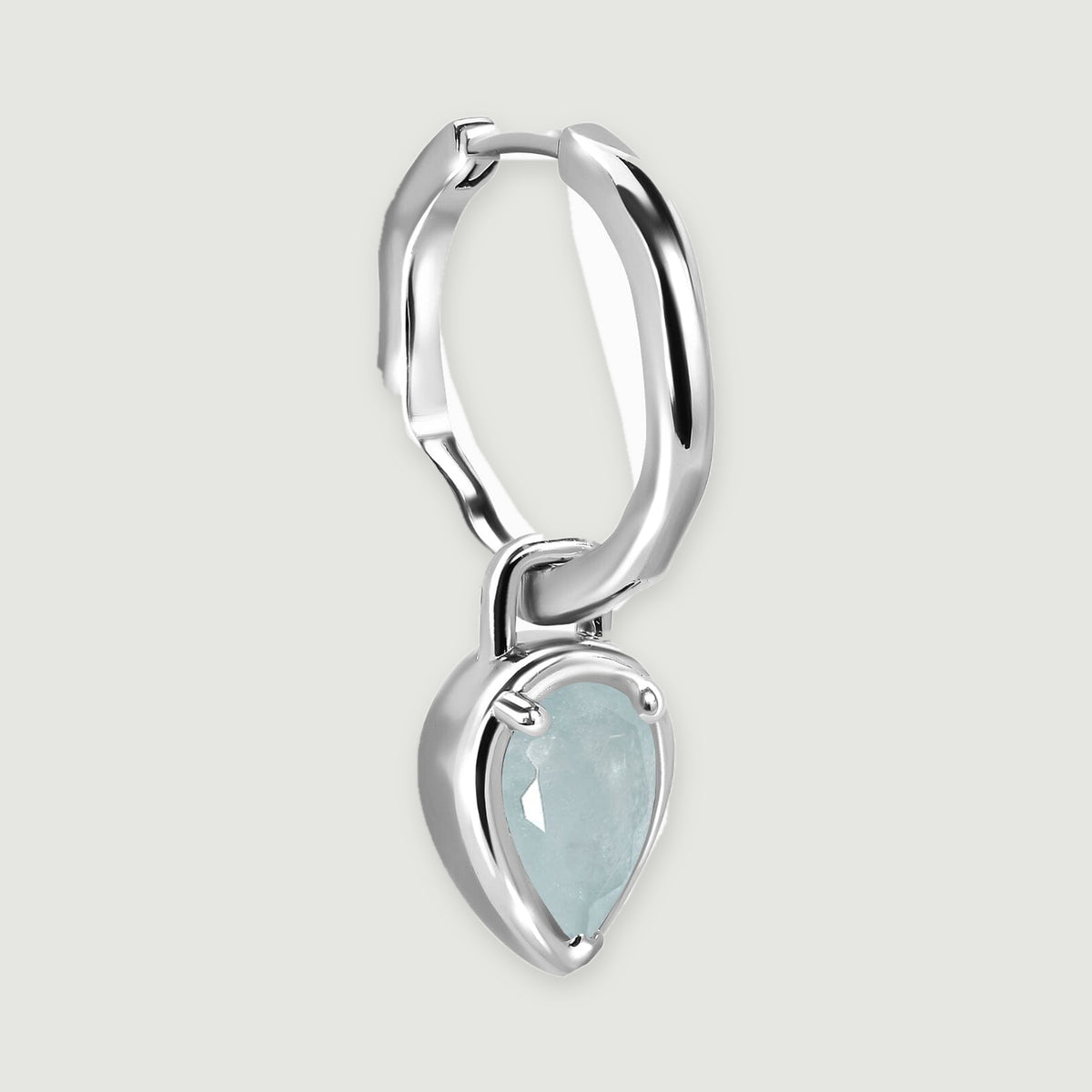 An angled silver-tone hoop reveals its hinged clasp, curved profile, and suspended aquamarine drop.