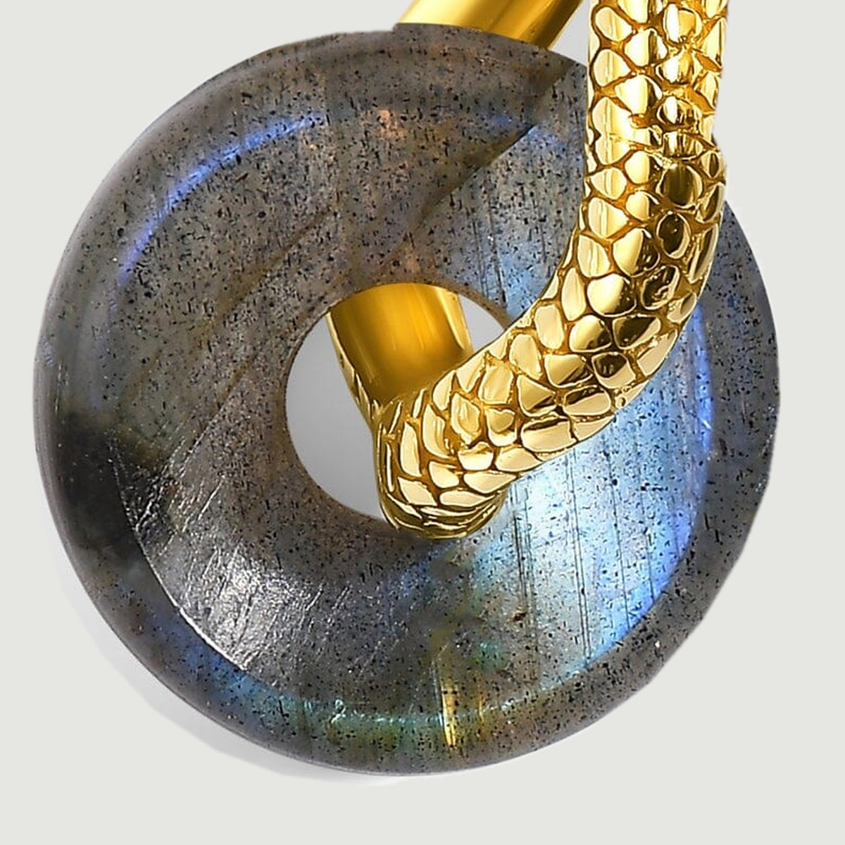 Blue and green reflections cross the rounded labradorite beneath a textured gold-tone hoop.