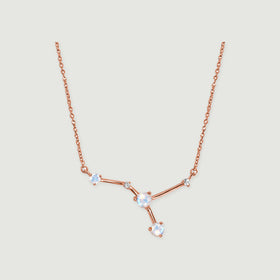 A rose gold vermeil chain leads to a branching arrangement of three pale stones and two smaller clear stones.