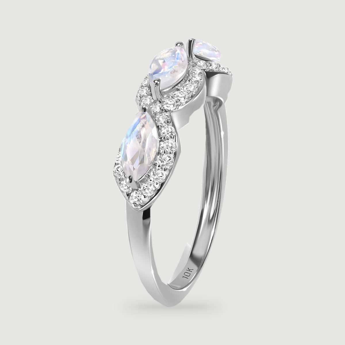 An upright white gold ring reveals the raised moonstone settings and smooth side of the band.