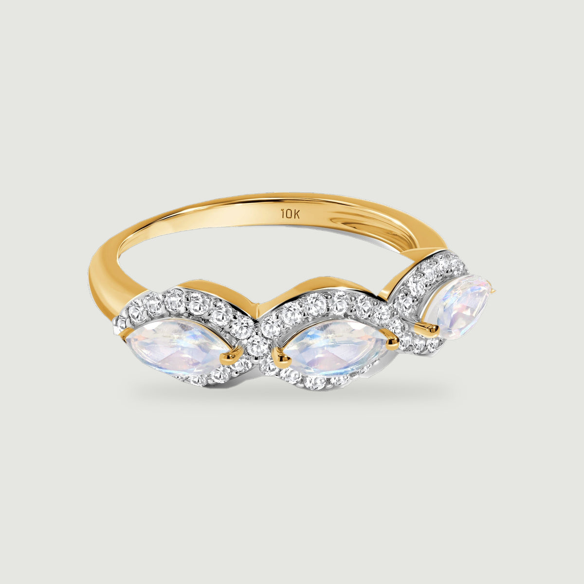 A yellow gold band supports three pale marquise moonstones framed by sparkling diamond curves.