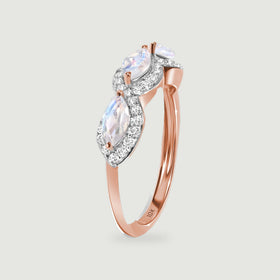 The side view of a rose gold ring shows elevated moonstones above a narrow rounded band.