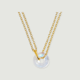 A yellow gold vermeil necklace with an open-centre moonstone pendant is shown against light grey.