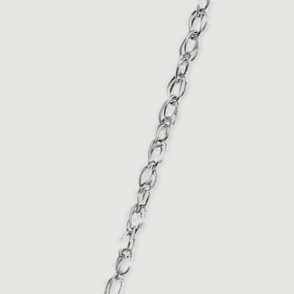 Interlocking white gold oval chain links run diagonally across a pale grey surface.