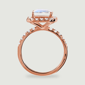 The side of a rose gold ring shows the raised moonstone, open gallery and polished circular band.