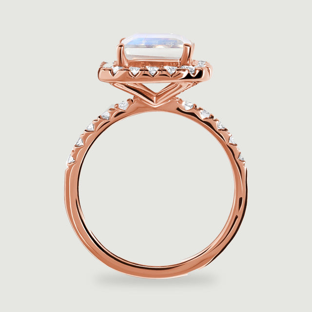 The side of a rose gold ring shows the raised moonstone, open gallery and polished circular band.