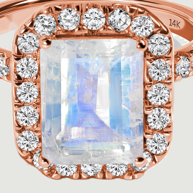 A close view shows the moonstone facets, rose gold corner prongs and surrounding round diamonds.