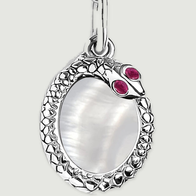 The white rhodium plated pendant is shown close up with its pearly center and raised textured border.