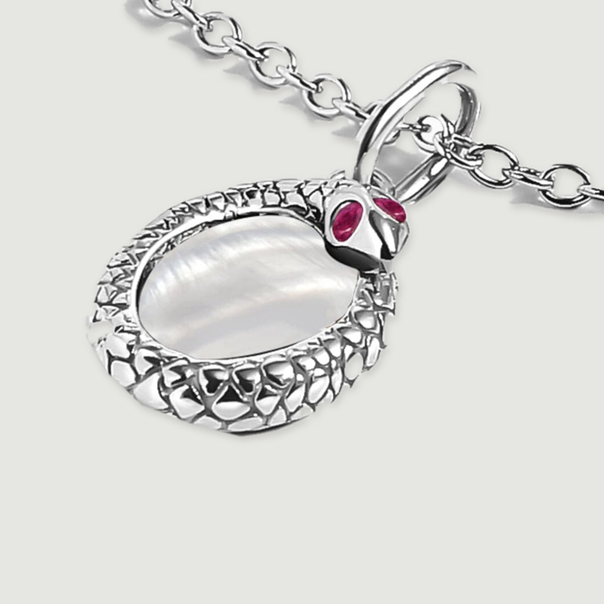 An angled view of the white rhodium plated pendant shows the raised edge, oval shell center, and connecting bail.